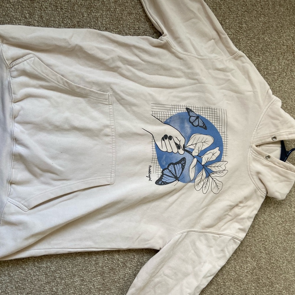 This is an oversized, tan printed madden girl sweatshirt.